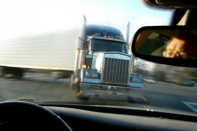 Semi-truck bearing down on vehicle — Dean & Camper P.A. truck accident injury attorneys